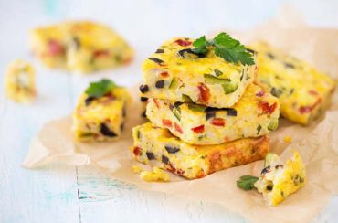 Homemade vegetarian rice frittata with zucchini, bell pepper and olives